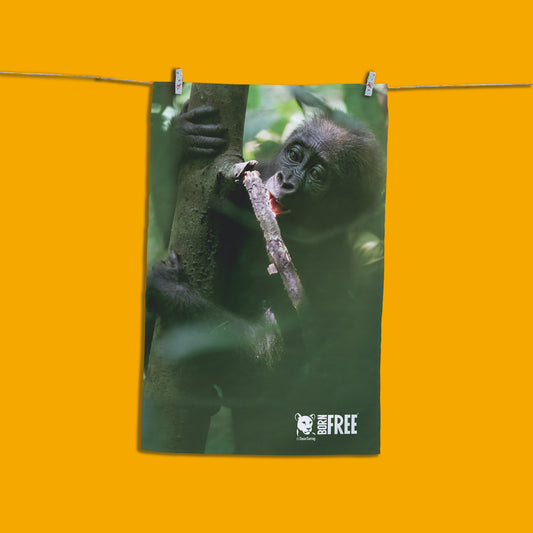 Baby chewing a small branch Organic Tea Towel by Dave Currey