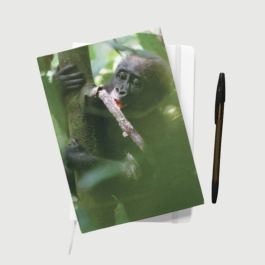 Baby chewing a small branch A5 Notepad by Dave Currey